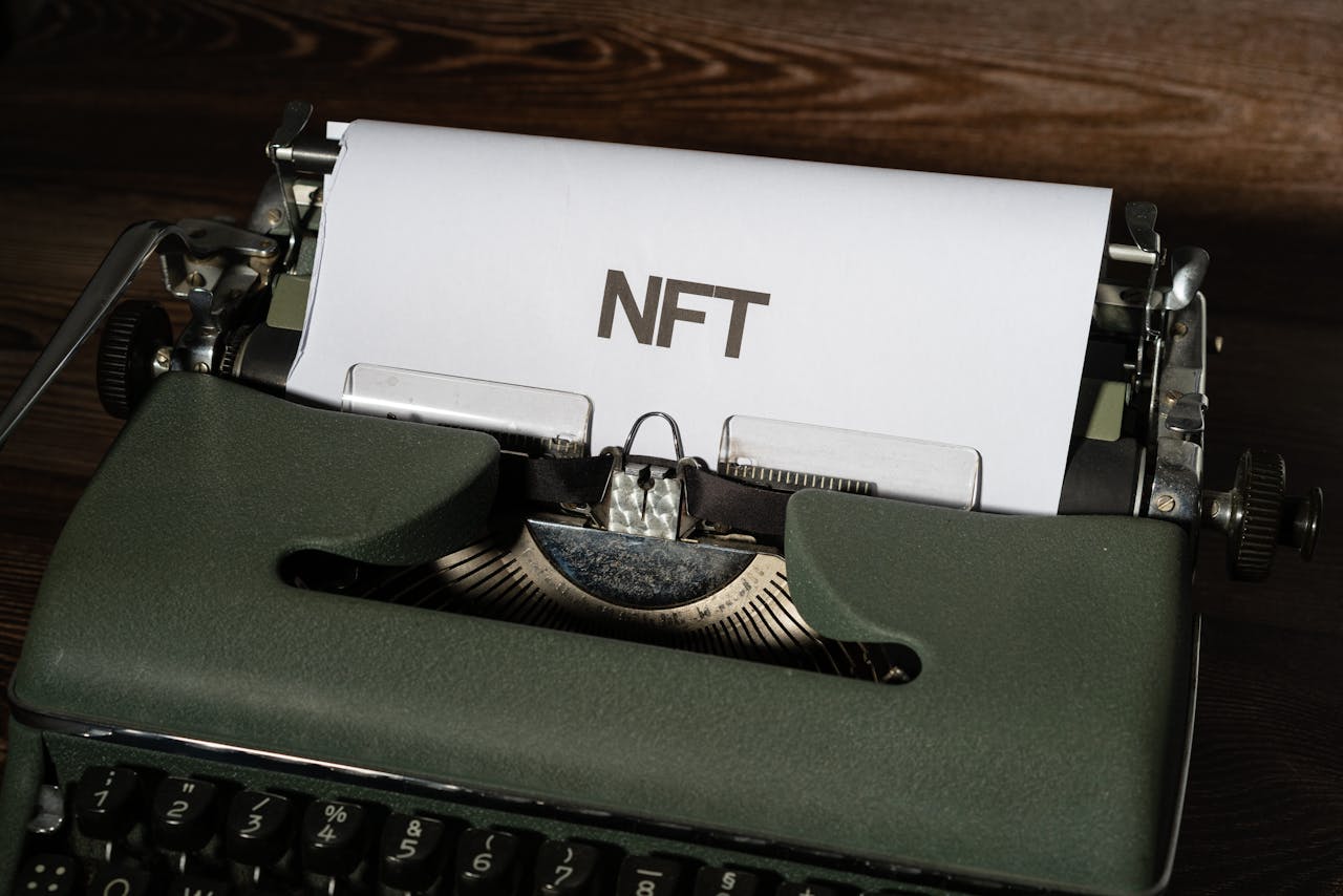 Close-up of a vintage typewriter with the word 'NFT' typed on paper, symbolizing digital innovation.